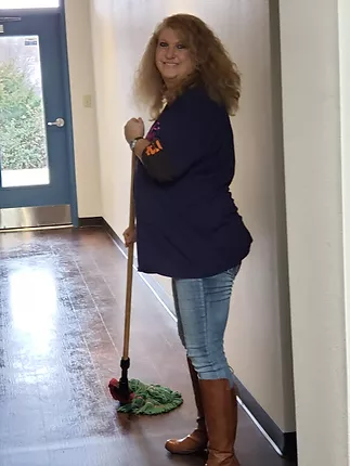 doco worker mopping a hallway