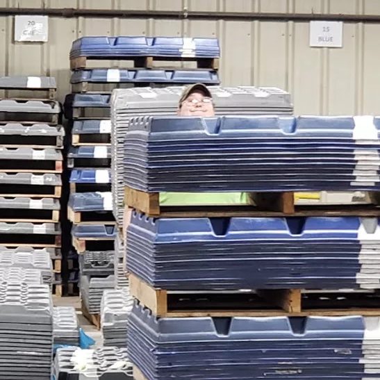 doco employee working with a stack of trays